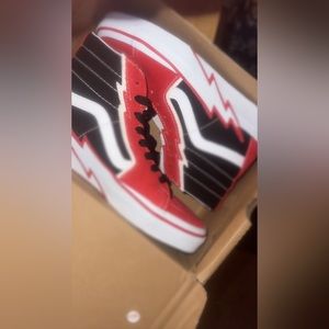 Red and black checker rockstar vans.